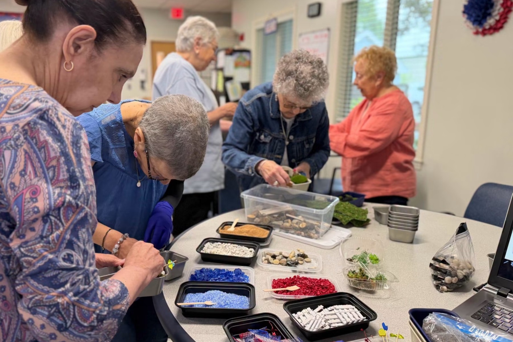 Participants creating Tiny Gardens together around a table during a real ProgramWorks experience.